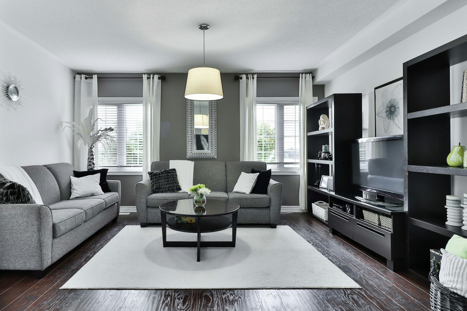 Dark stained hardwood floor surrounding a rug