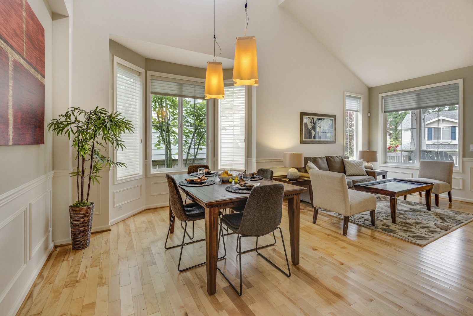 Light oak hardwood floor through a dining room and living room